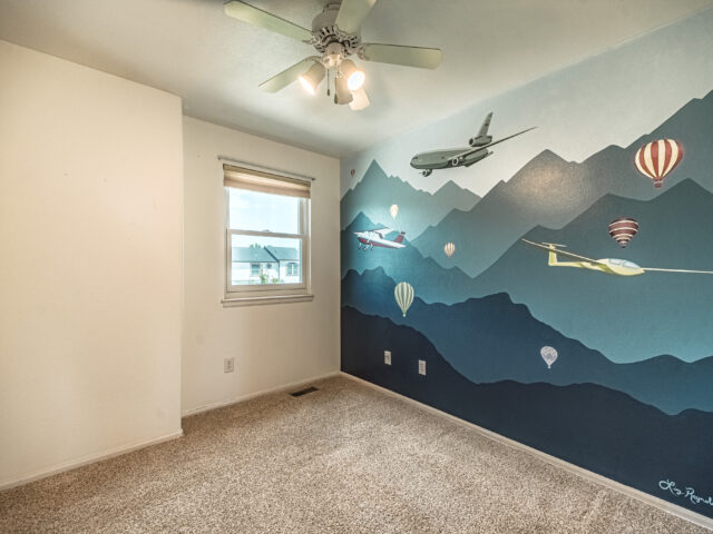 Airplane Room with a mural of aircraft flying over blue mountains
